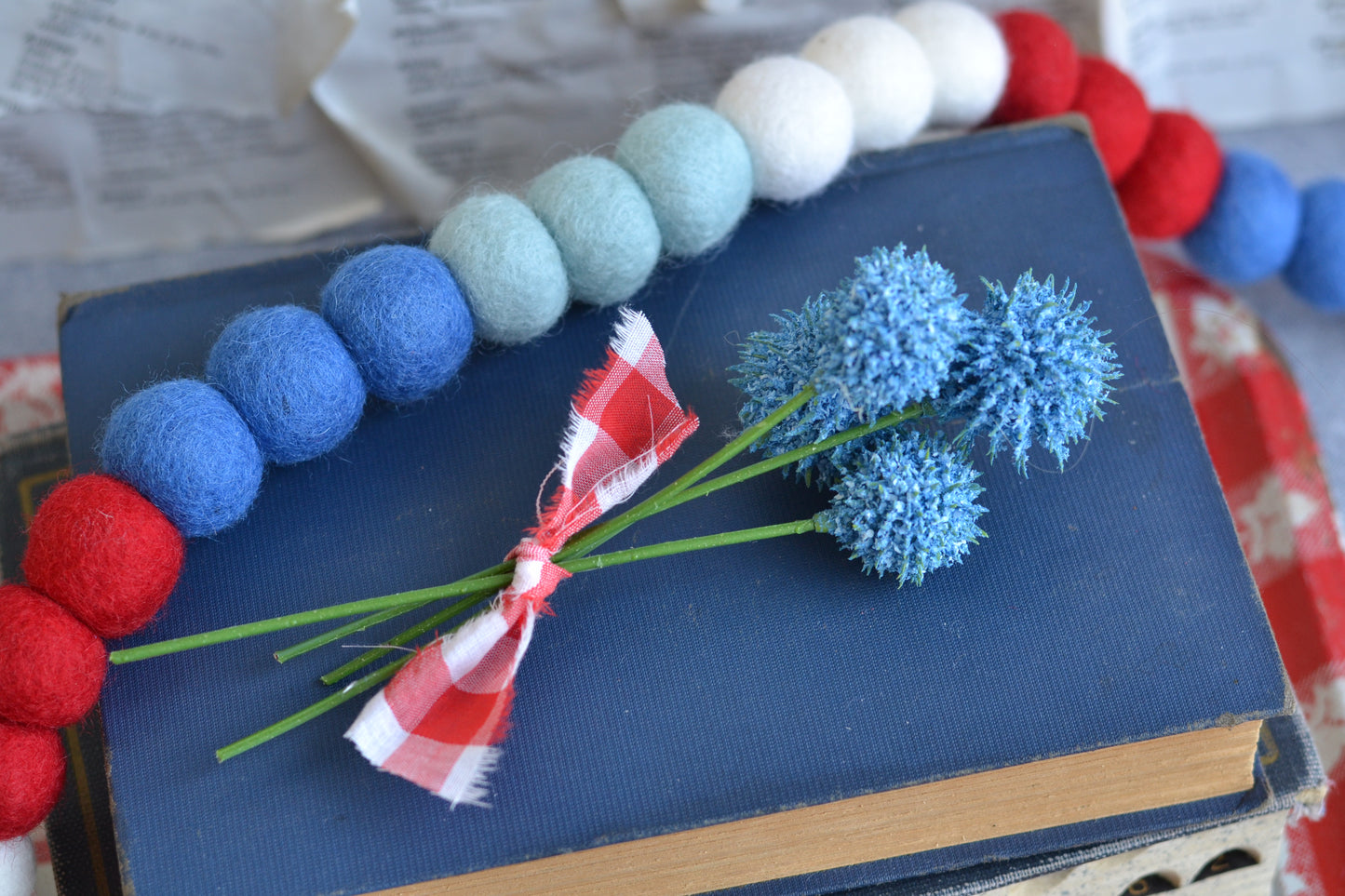 Bundle of blue faux flowers with gingham fabric ribbon tie