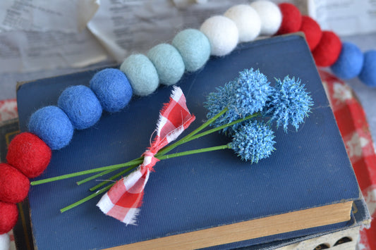 Bundle of blue faux flowers with gingham fabric ribbon tie